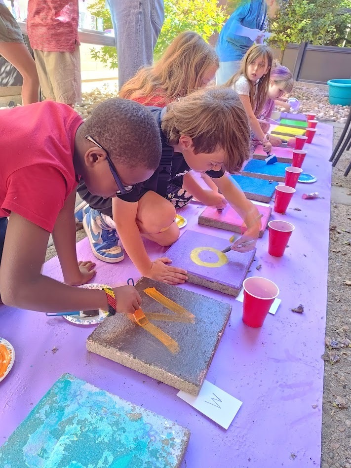 Students painting steppingstones.