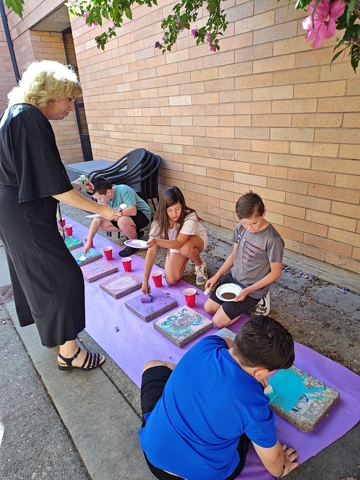 Students painting steppingstones.