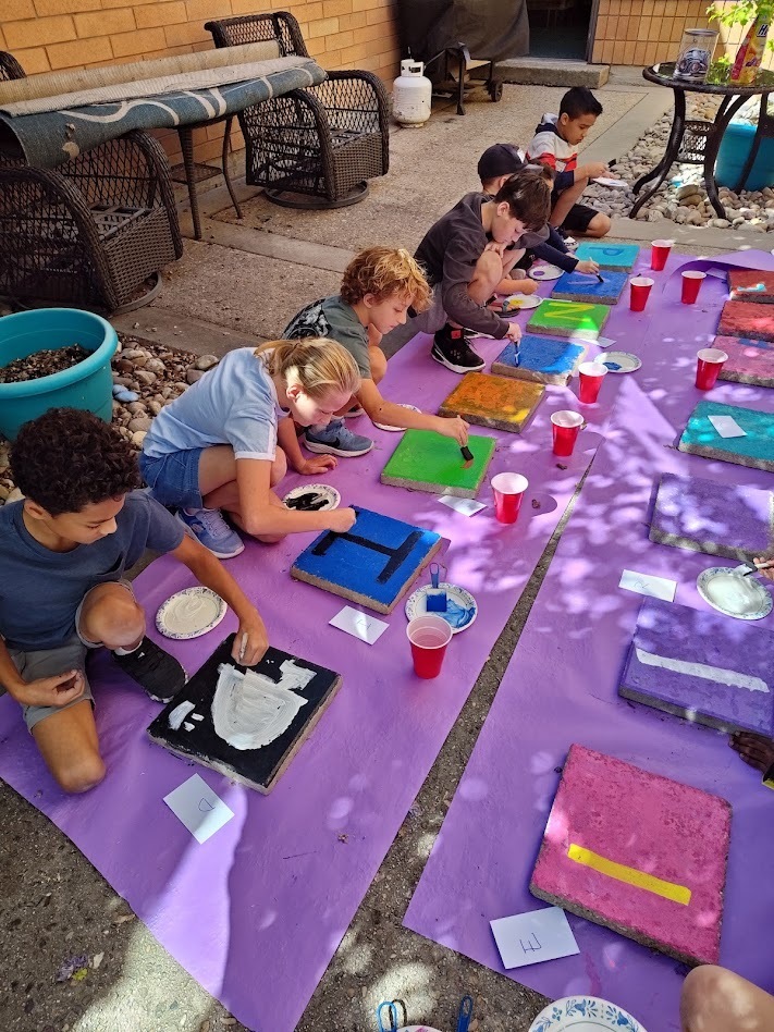 Students painting steppingstones.