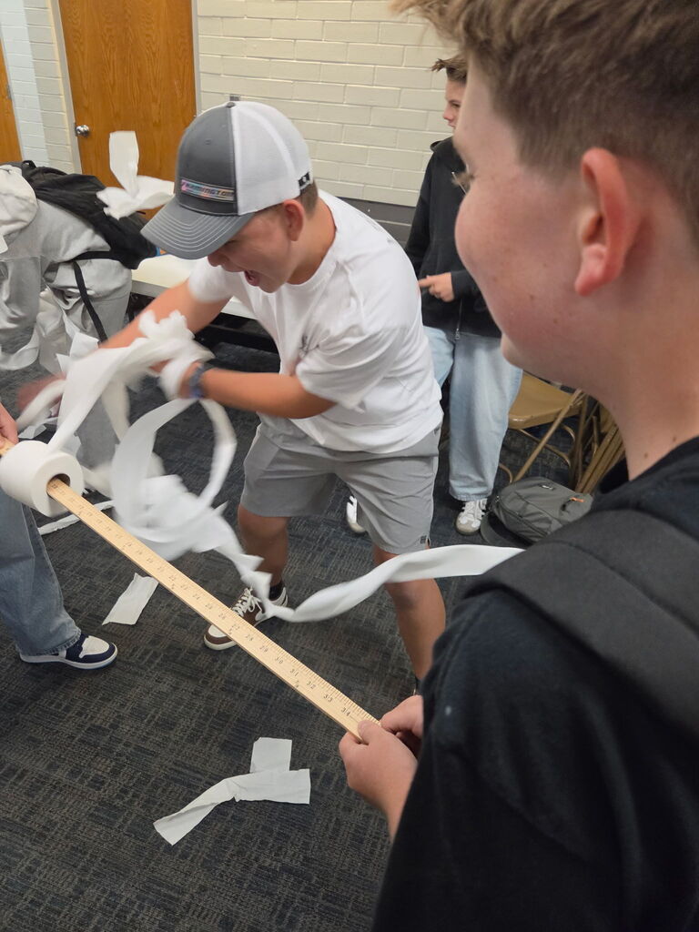 Final photo of student unrolling toilet paper quickly lunchtime activity. 