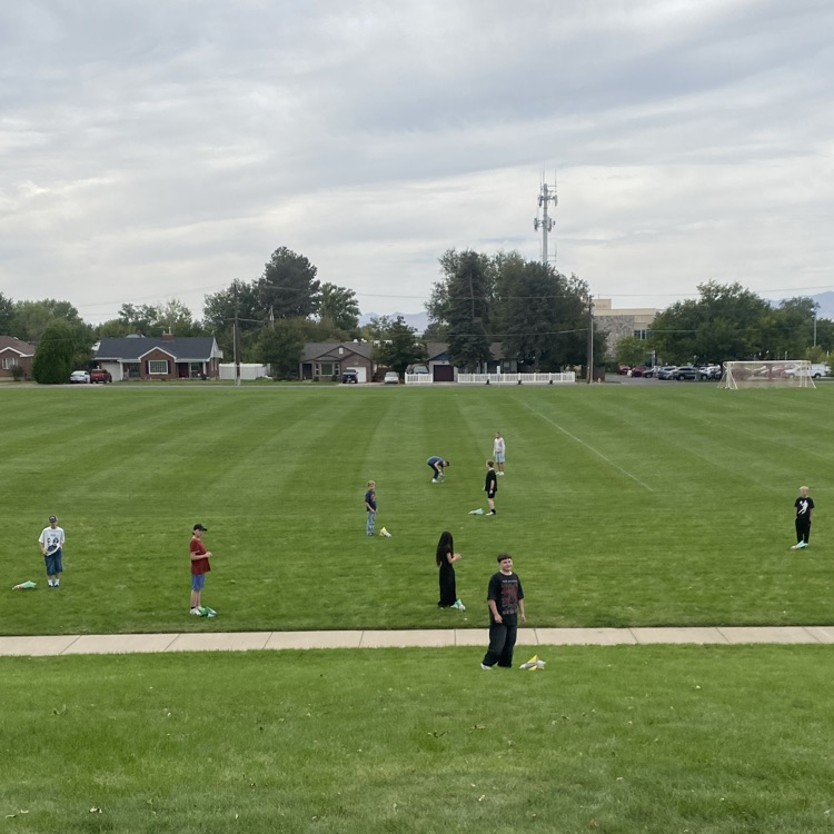 students standing where their rocket landed