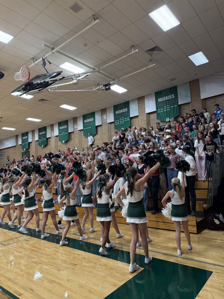 Cheerleaders and student section cheering on the team. 