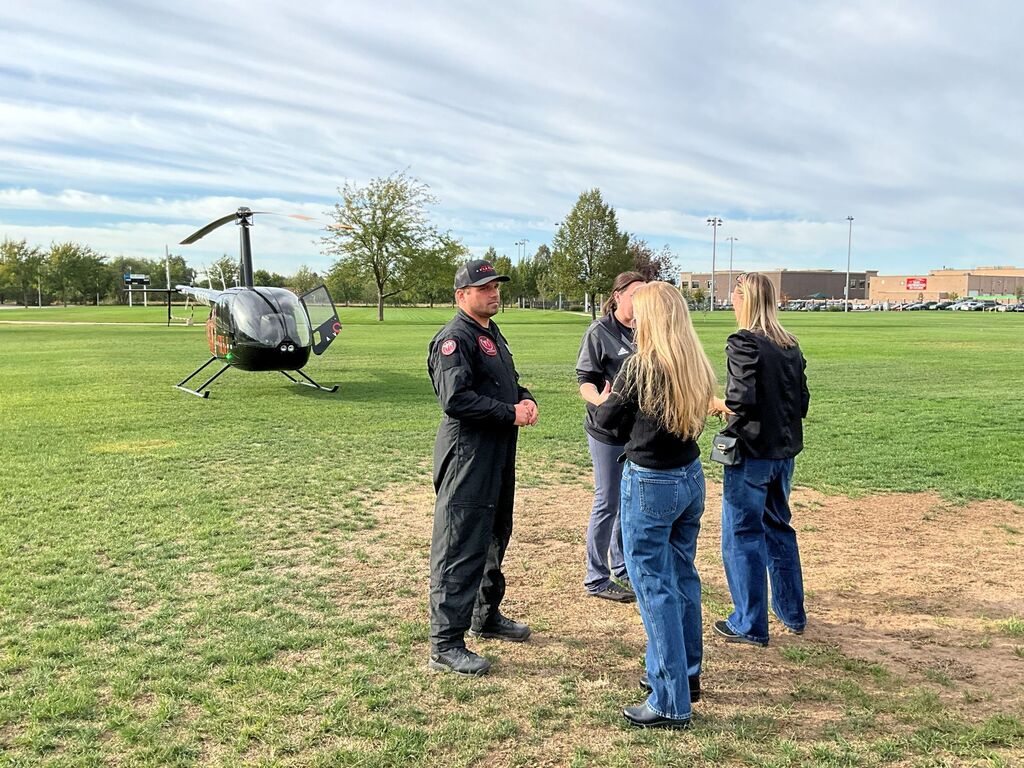 Students watch the SUU chopper land and meet the pilots to learn more about the program.
