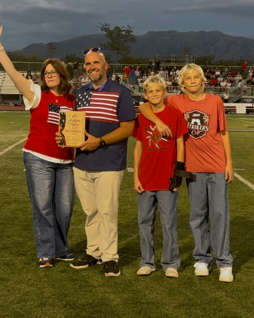 A family poses with Principal Brad Chapple.