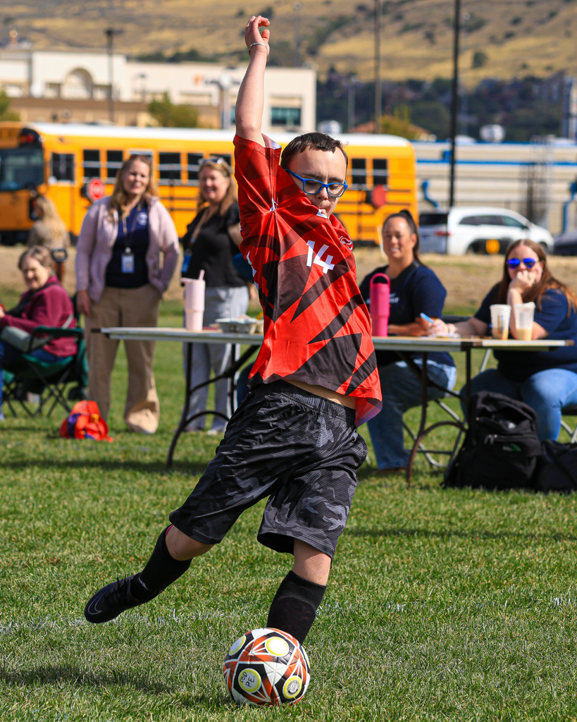 A student about to kick the soccerball during a game.