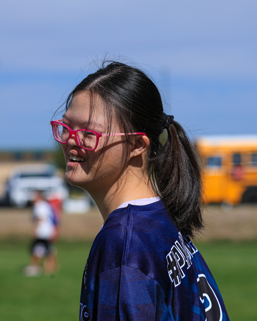 A student smiles during a soccer game.