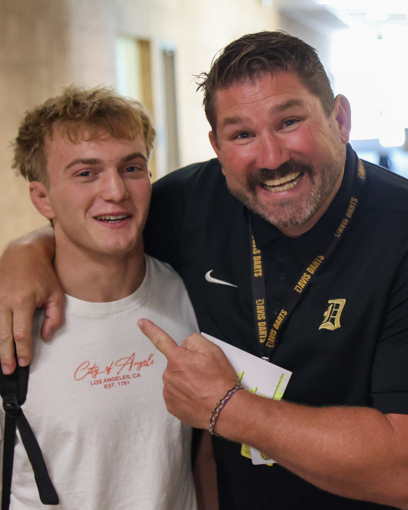A teacher and a student smiling.