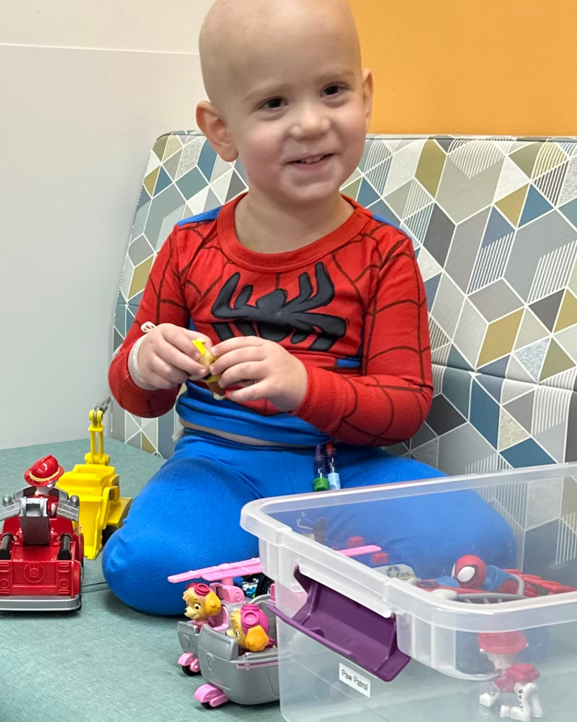 A student smiling while playing with toys.