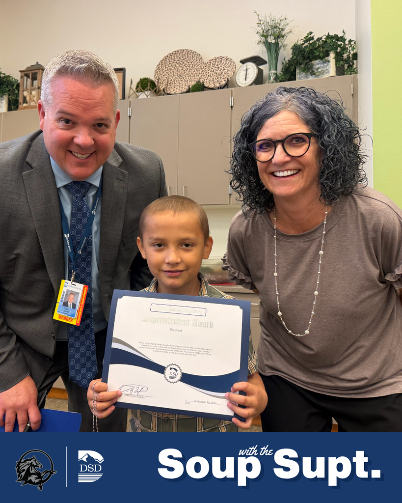A student smiling with their principal and the superintendent during Soup with the Supt. 