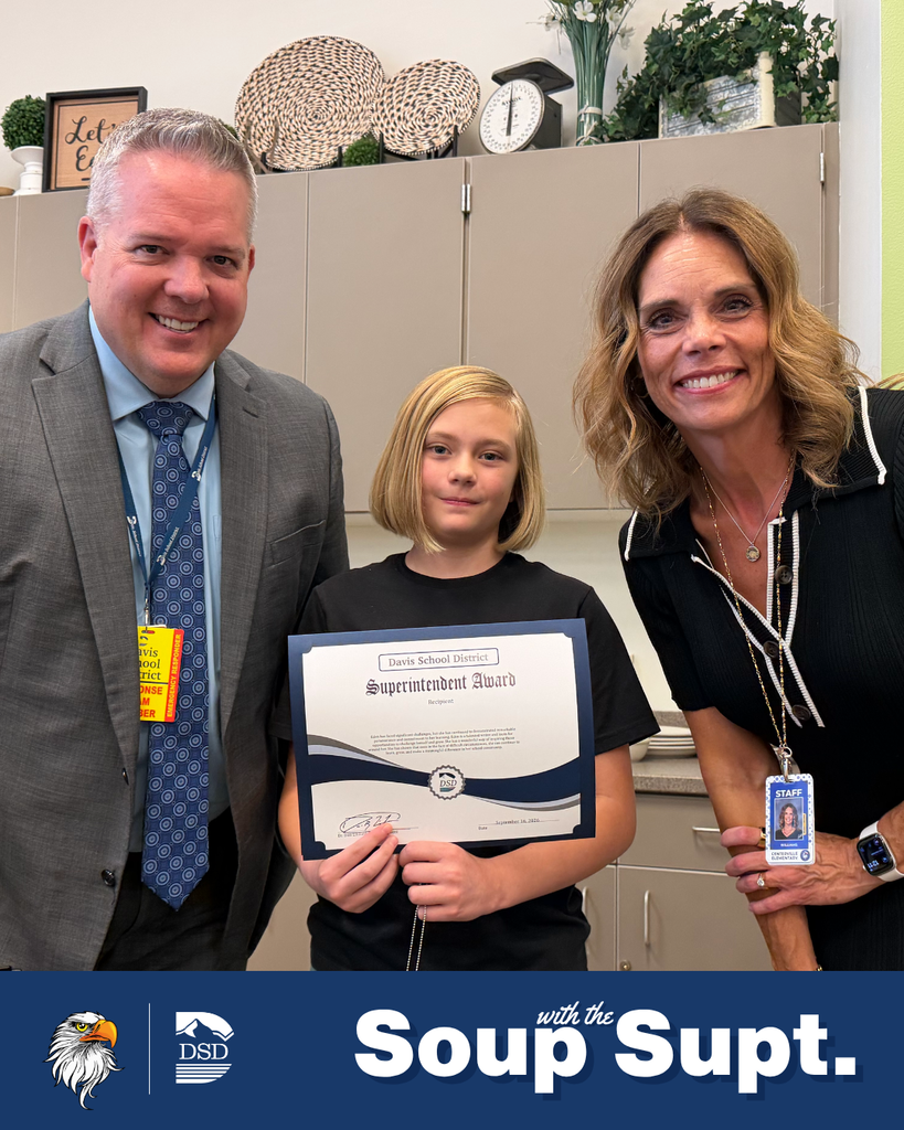 A student smiling with their principal and the superintendent during Soup with the Supt. 