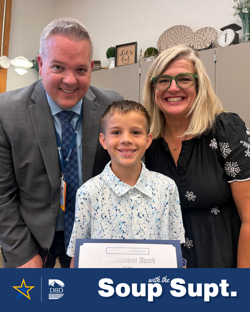 A student smiling with their principal and the superintendent during Soup with the Supt. 