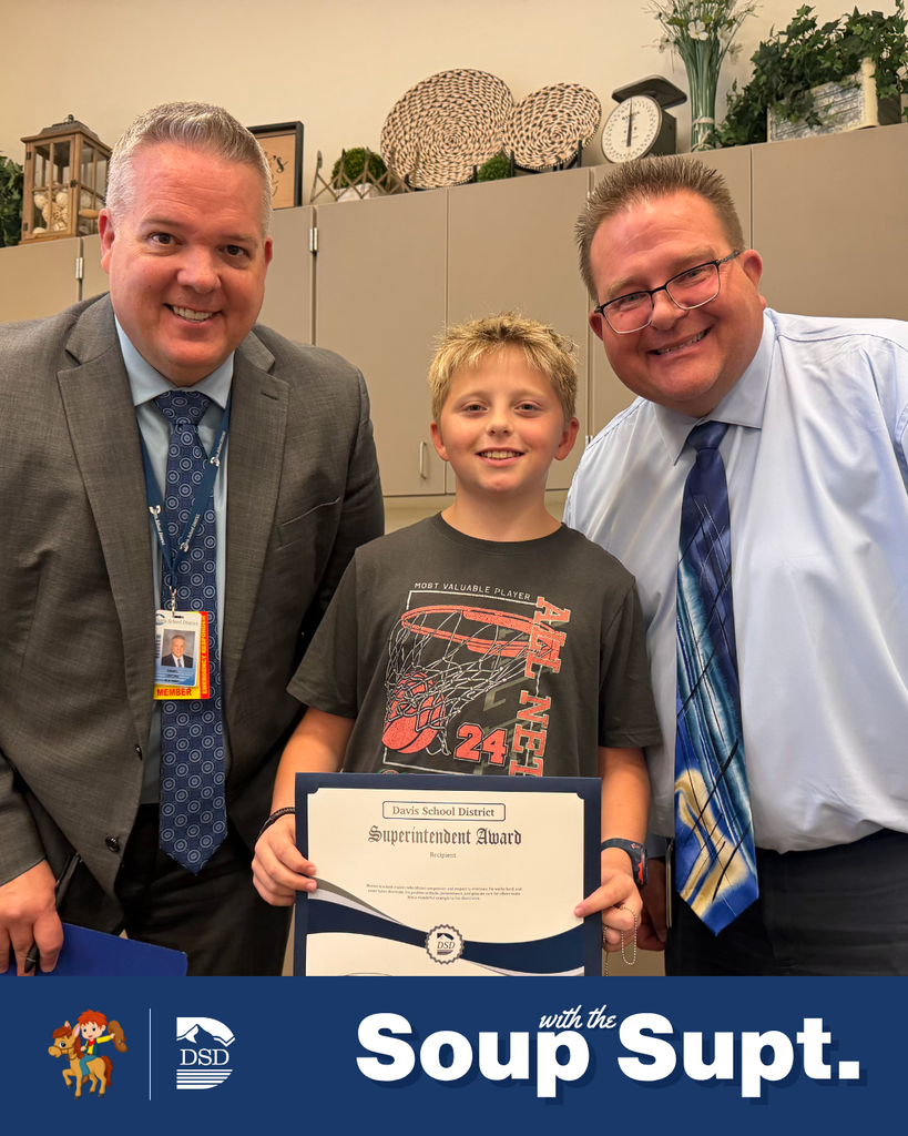 A student smiling with their principal and the superintendent during Soup with the Supt. 