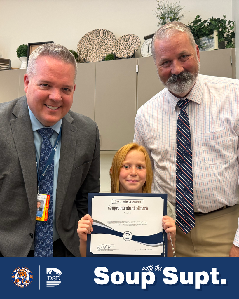 A student smiling with their principal and the superintendent during Soup with the Supt. 