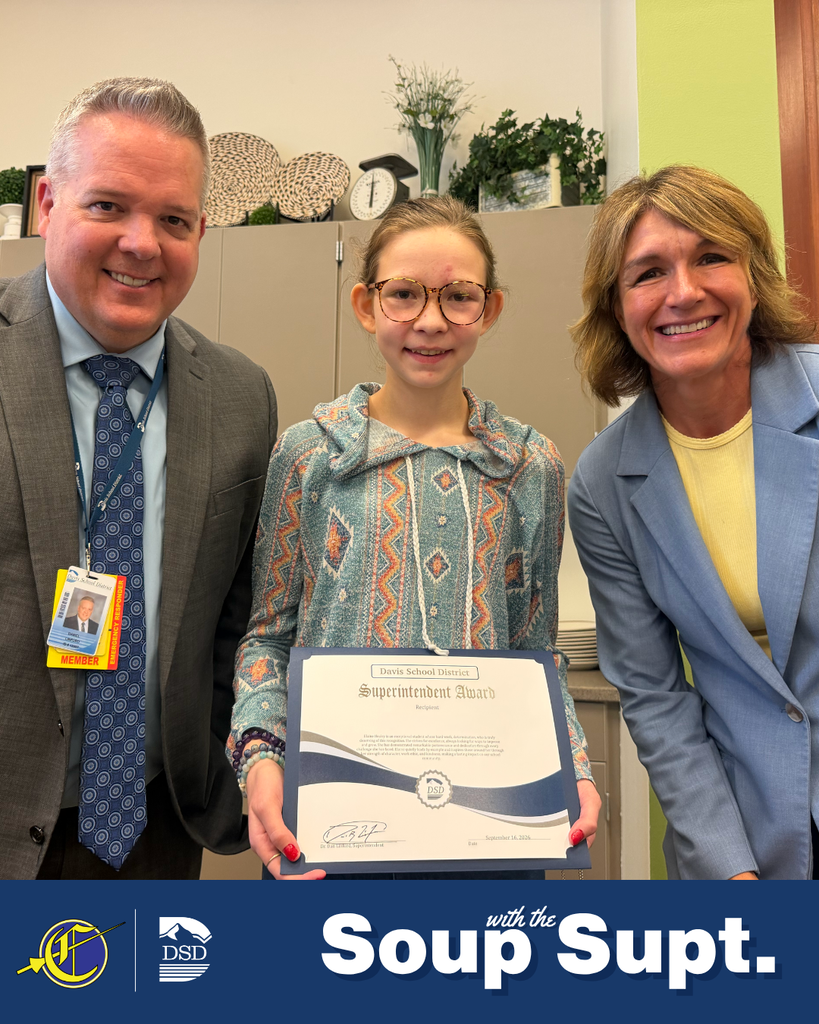 A student smiling with their principal and the superintendent during Soup with the Supt. 