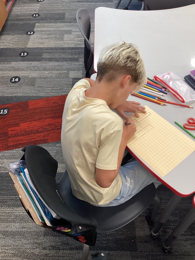 Student sitting at desk working on an assignment.