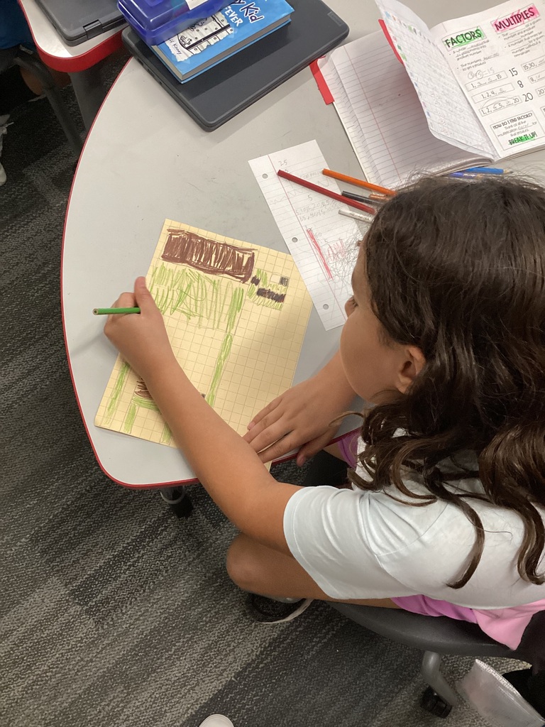 Student sitting at desk working on an assignment.