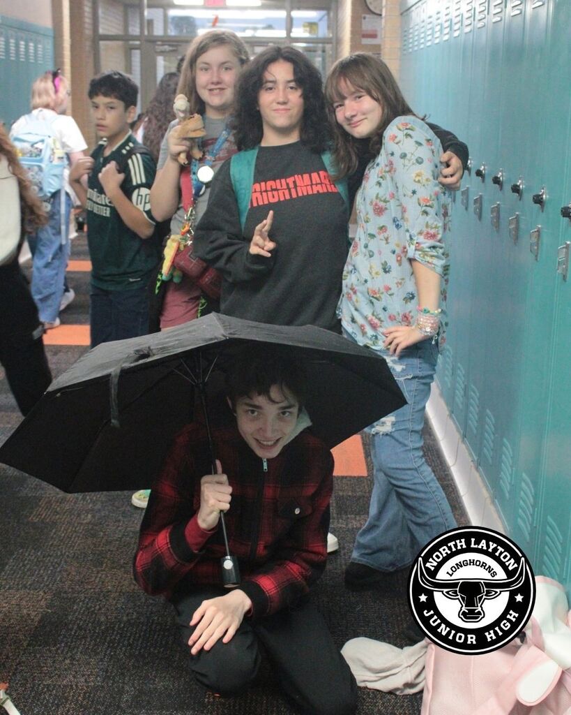 group of students standing in the hallway