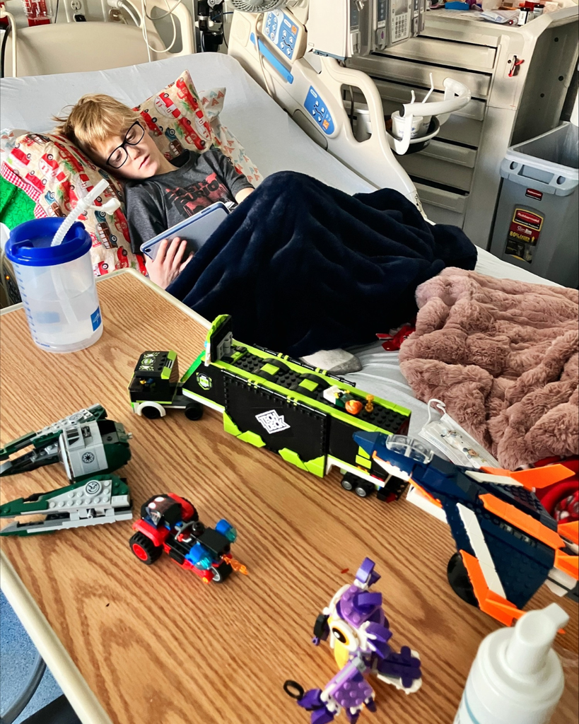 A student in the hospital with legos. 
