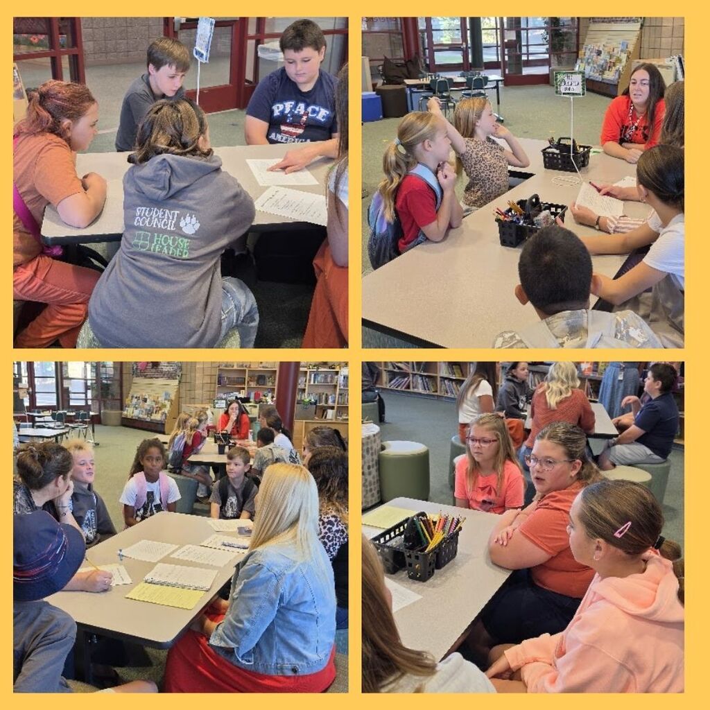 Students gather around a table to discuss House Members of the Month.