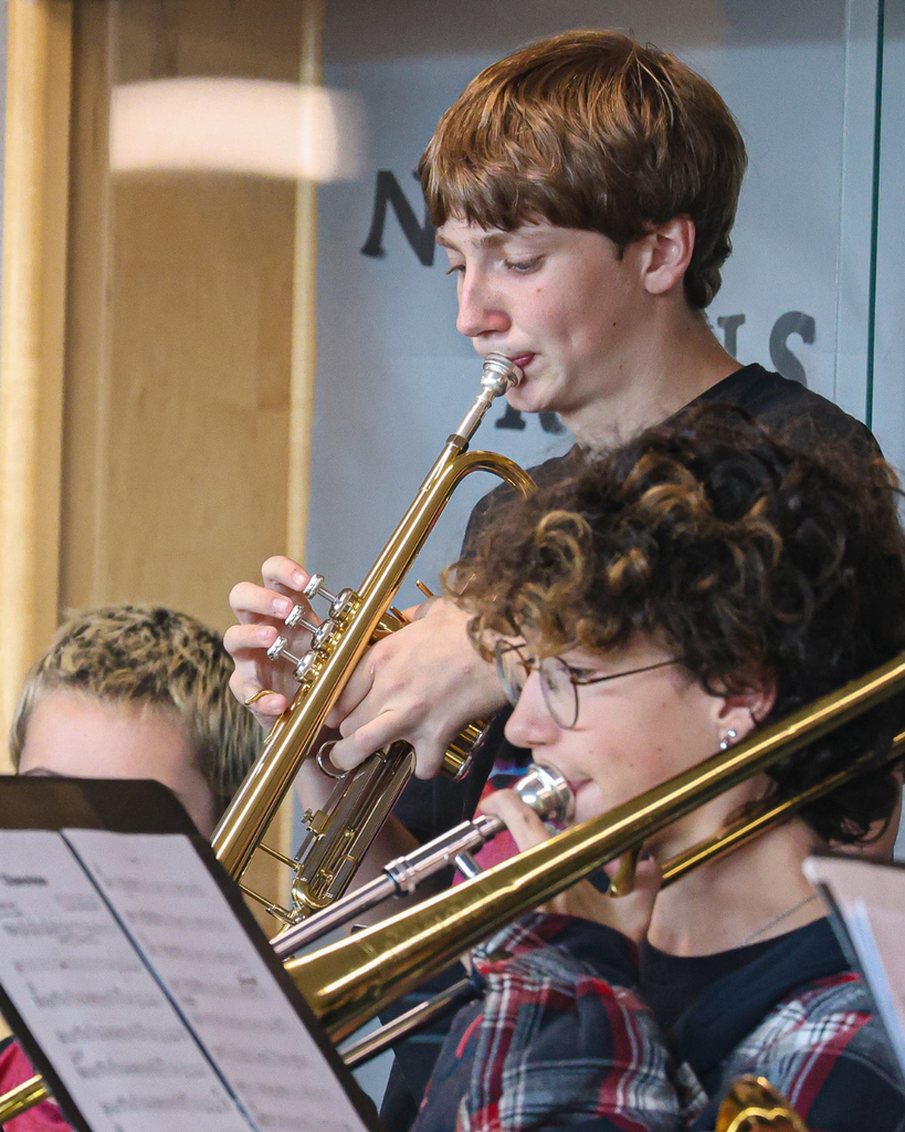 Students playing a trumpet and trombone. 