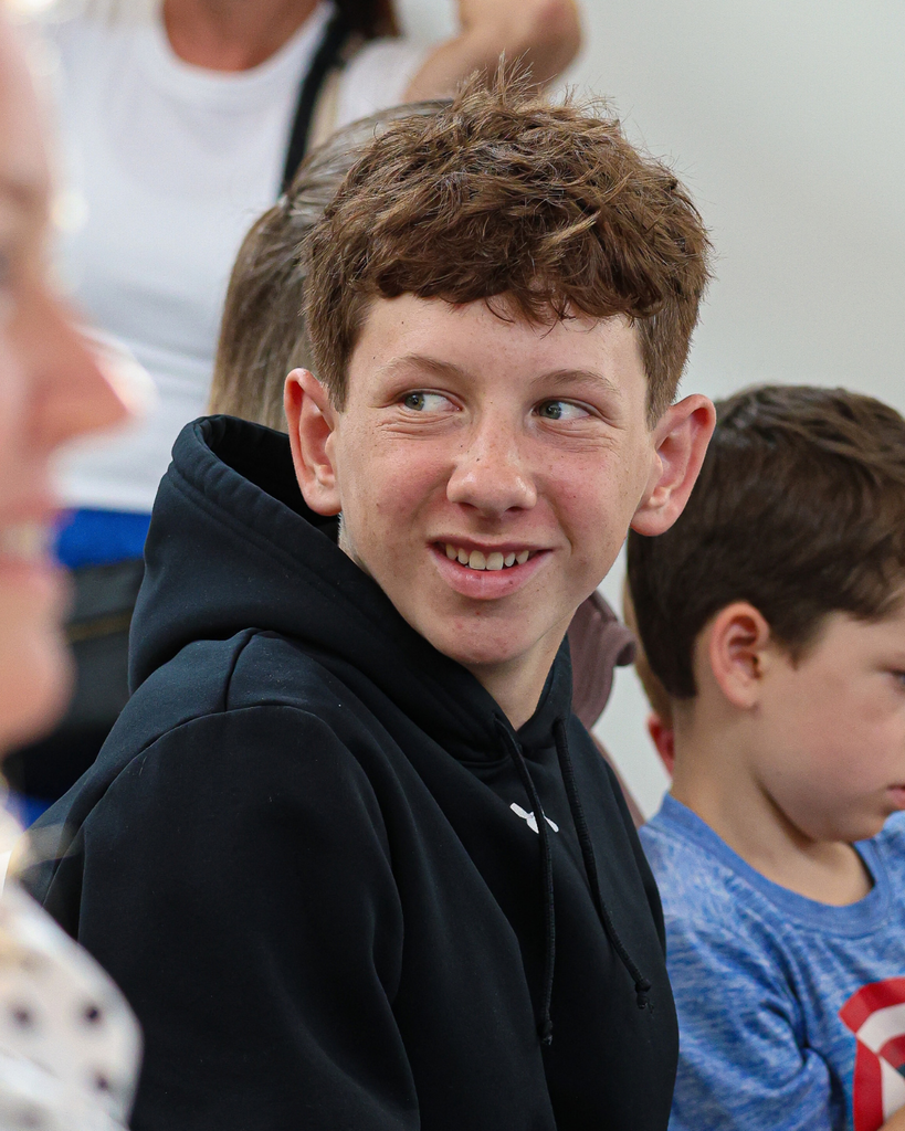 A student looking over their shoulder smiling. 