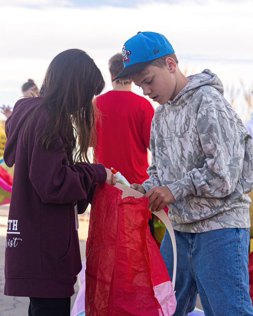 Students working together to fix their hot air balloons and patch holes. 