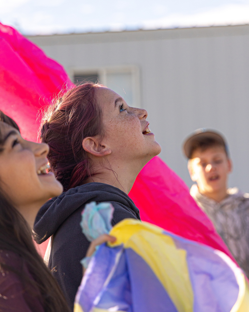 Students looking up to the sky in awe. 