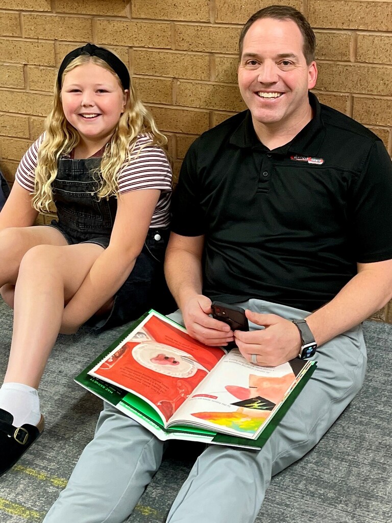 Picture of dad & daughter with a book