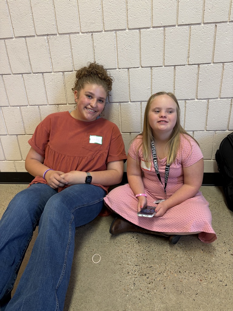 image of students sitting on the floor