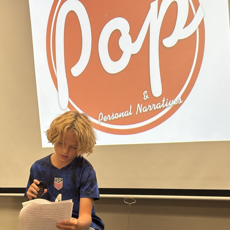 student reading his own writing