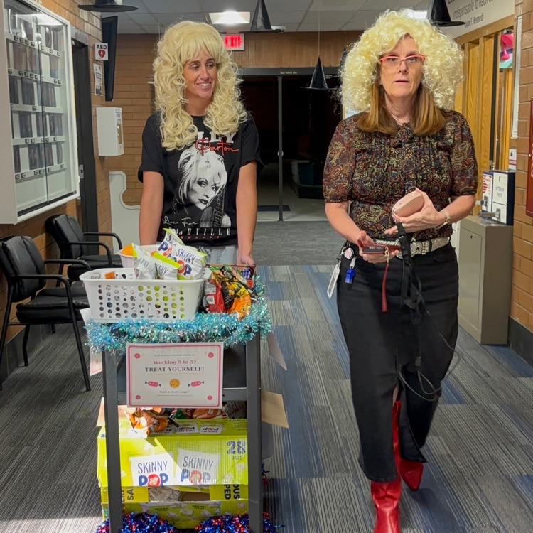 women dressed as Dolly Parton pushing a treat cart