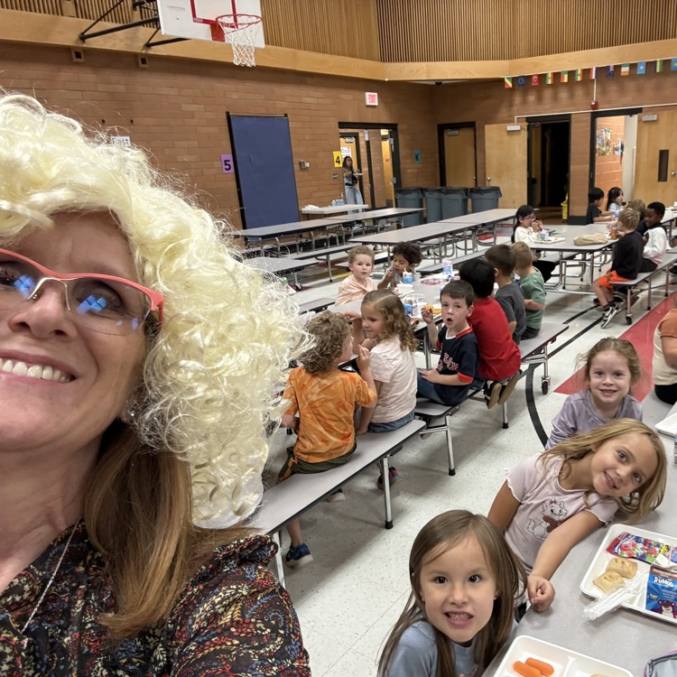ms Barlow in lunchroom dressed as Dolly Parton