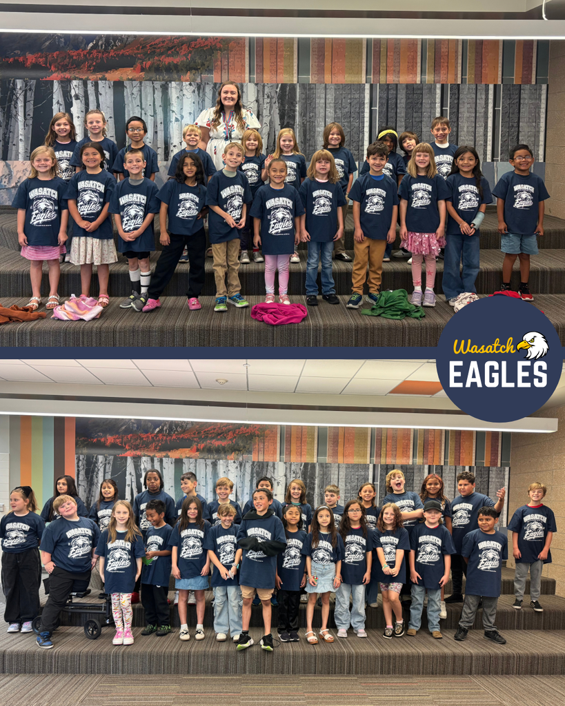 Photo collage featuring two classes of Wasatch Elementary students wearing matching navy blue Wasatch Eagles T-shirts. The top photo shows a class standing on tiered seating in front of a wall mural with a staff member positioned in the center of the group. The bottom photo shows a larger class gathered on the same tiered seating area for a group picture. Students are arranged in several rows and are wearing matching school spirit shirts. The background includes a large mural with tree and mountain imagery, and the Wasatch Eagles logo appears on the right side of the collage. The images highlight school pride and participation in a Wasatch Eagles spirit day.