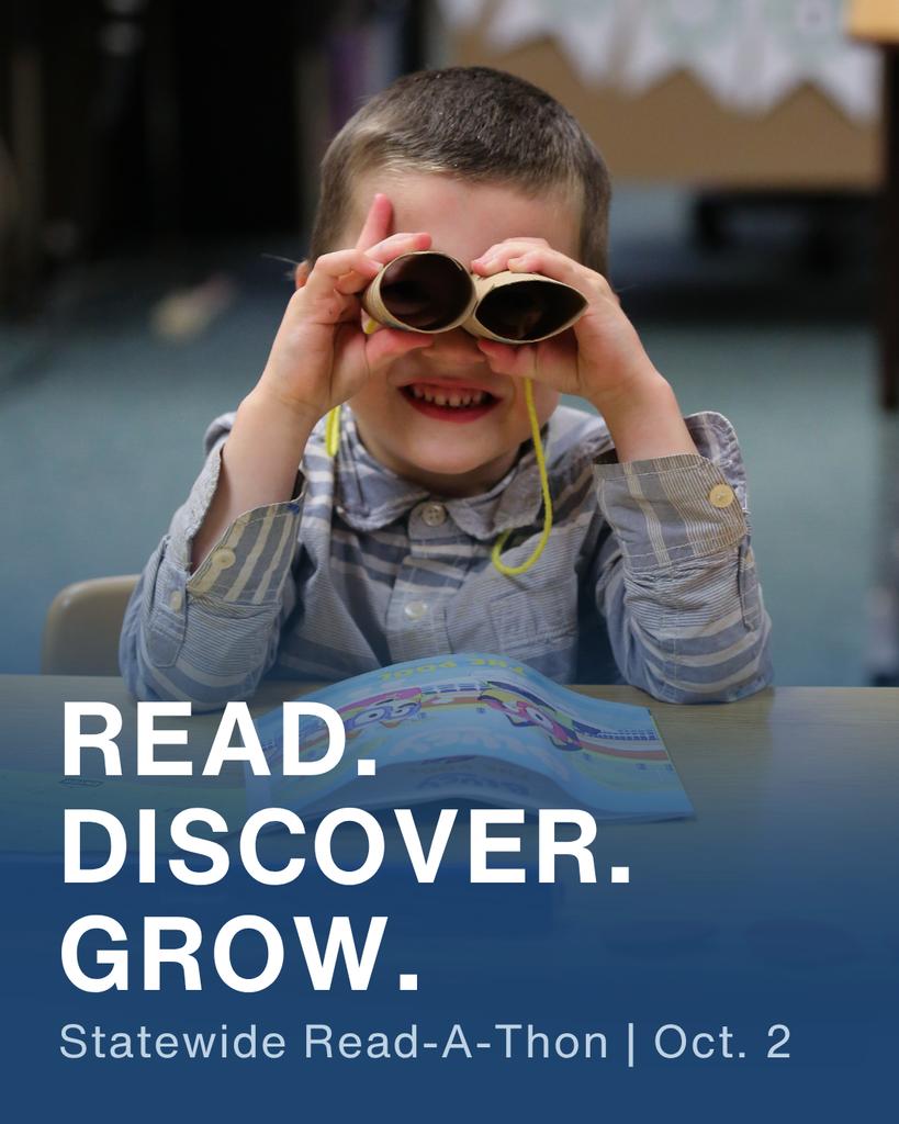 a child looking through a homemade pair of binoculars at a read a thon