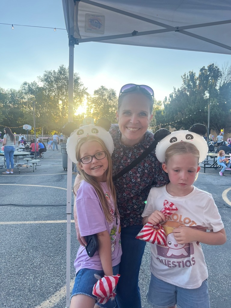 Mother and her two daughters at their local elementary school carnival