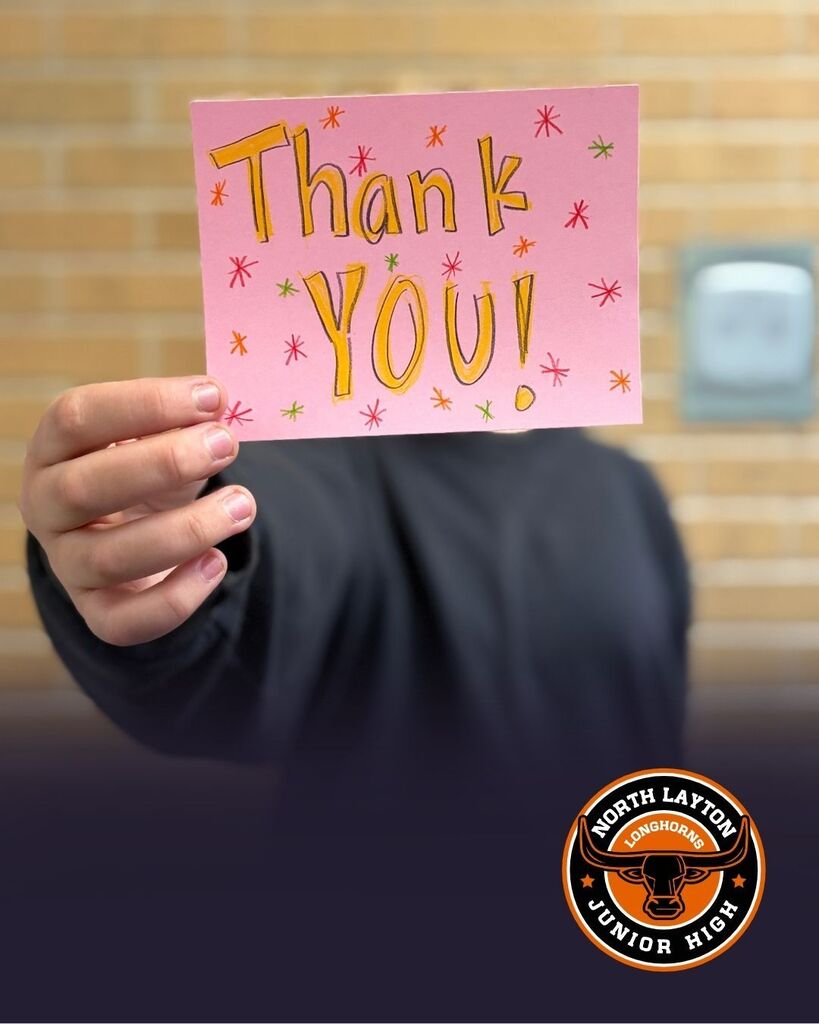 a student holding a thank you card for first resonders