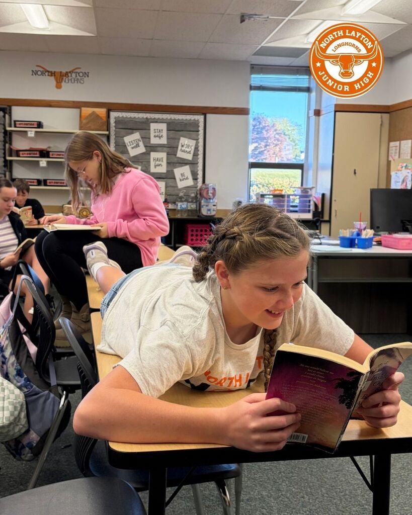 students sit on desks reading during Utah's read a thon