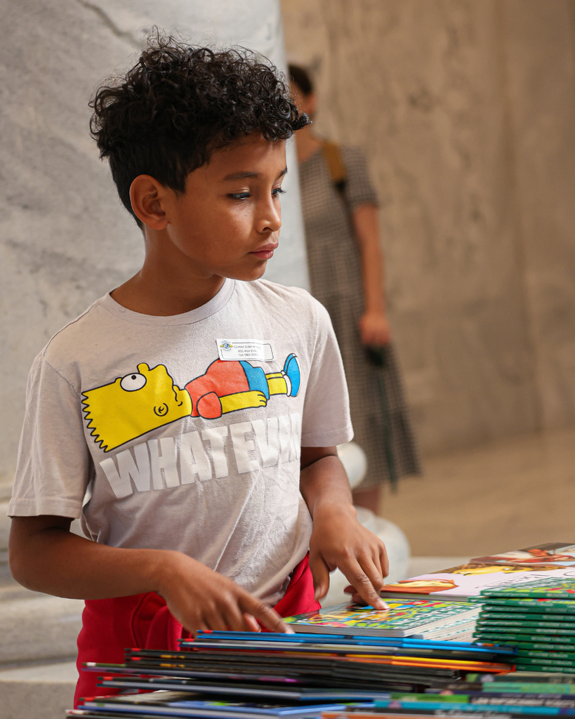 A Davis School District student looking at books at the Utah Reads Read-A-Thon at the Utah State Capitol. 