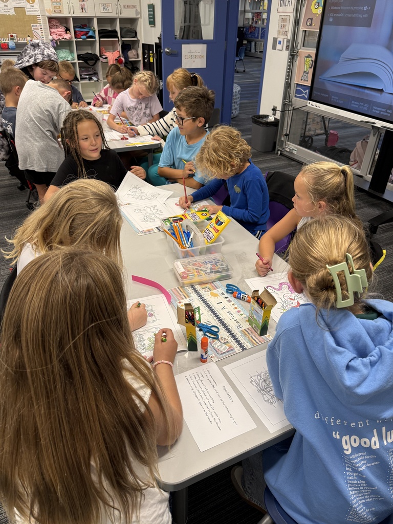 group of students around a table coloring with crayons