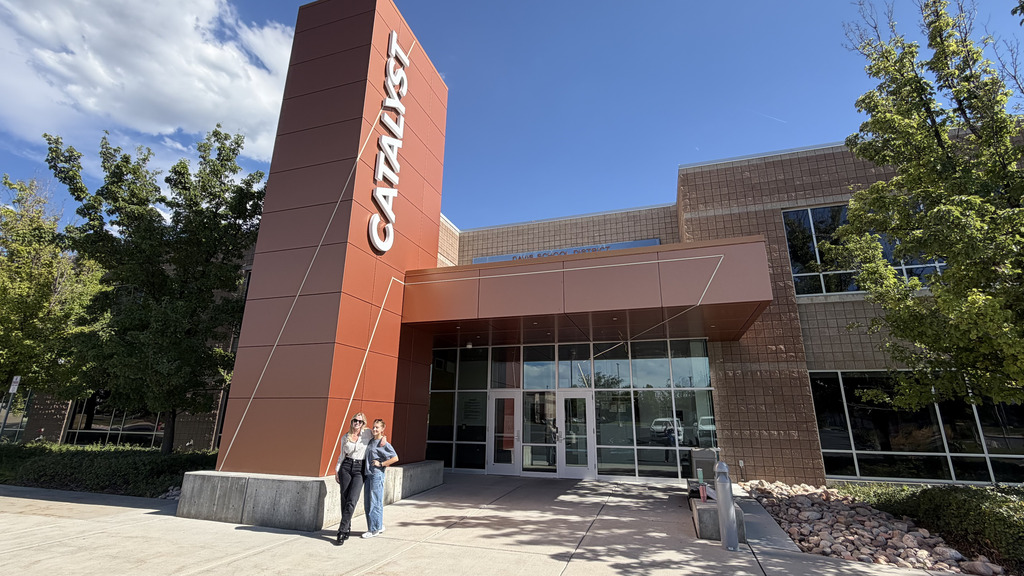 Kailee Calder and Megan Barker pose in front of the Catalyst Center