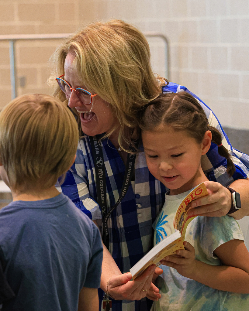 A teacher celebrates a book with a student.