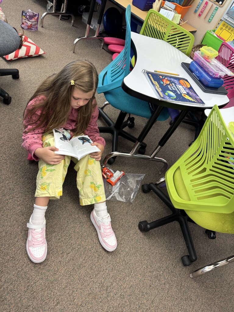girl reading a book in class