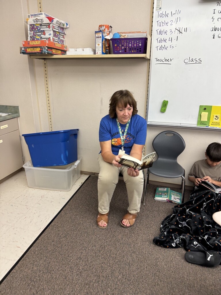 Teacher reading book in classroom