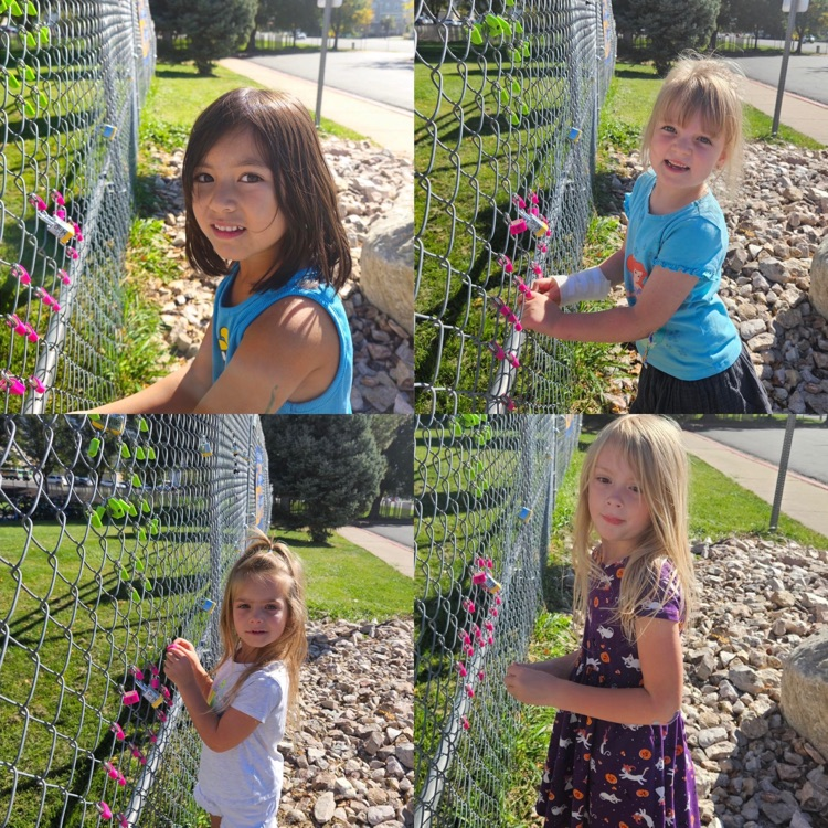 kindergarteners hanging their lock on the fence as a class