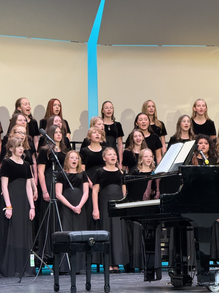 Female students singing at the concert. 