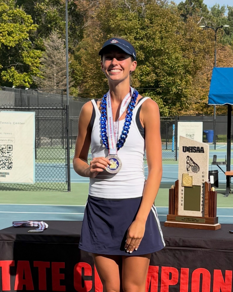 Woods Cross High School tennis player holding their medal after the state championships.