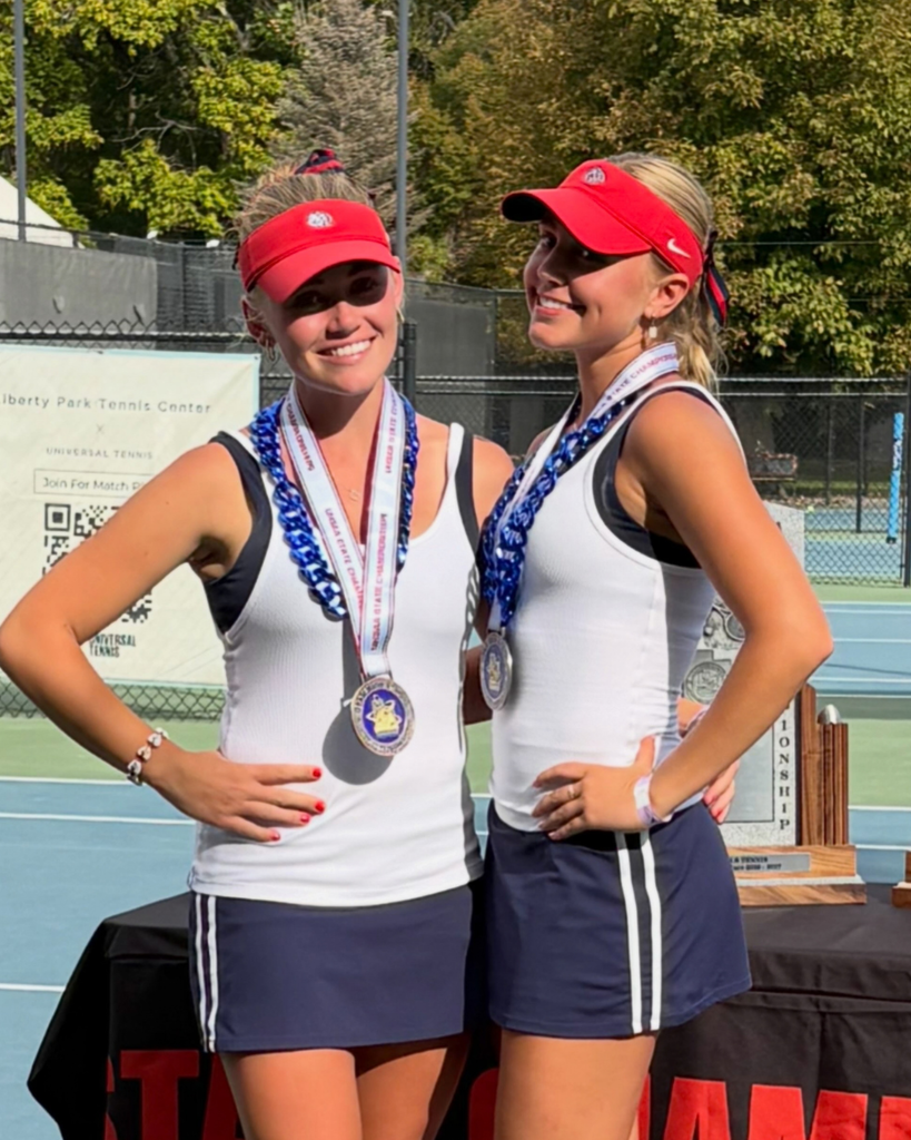 Two Woods Cross High School tennis players smiling after the state tournament. 