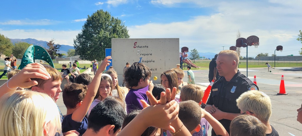 boys and girls in a 4th grade class speaking to a fireman