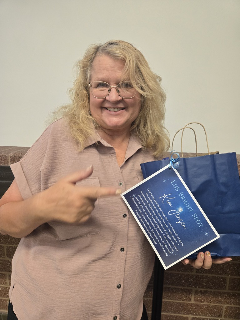 Mrs. Jensen posing with her bright spot award