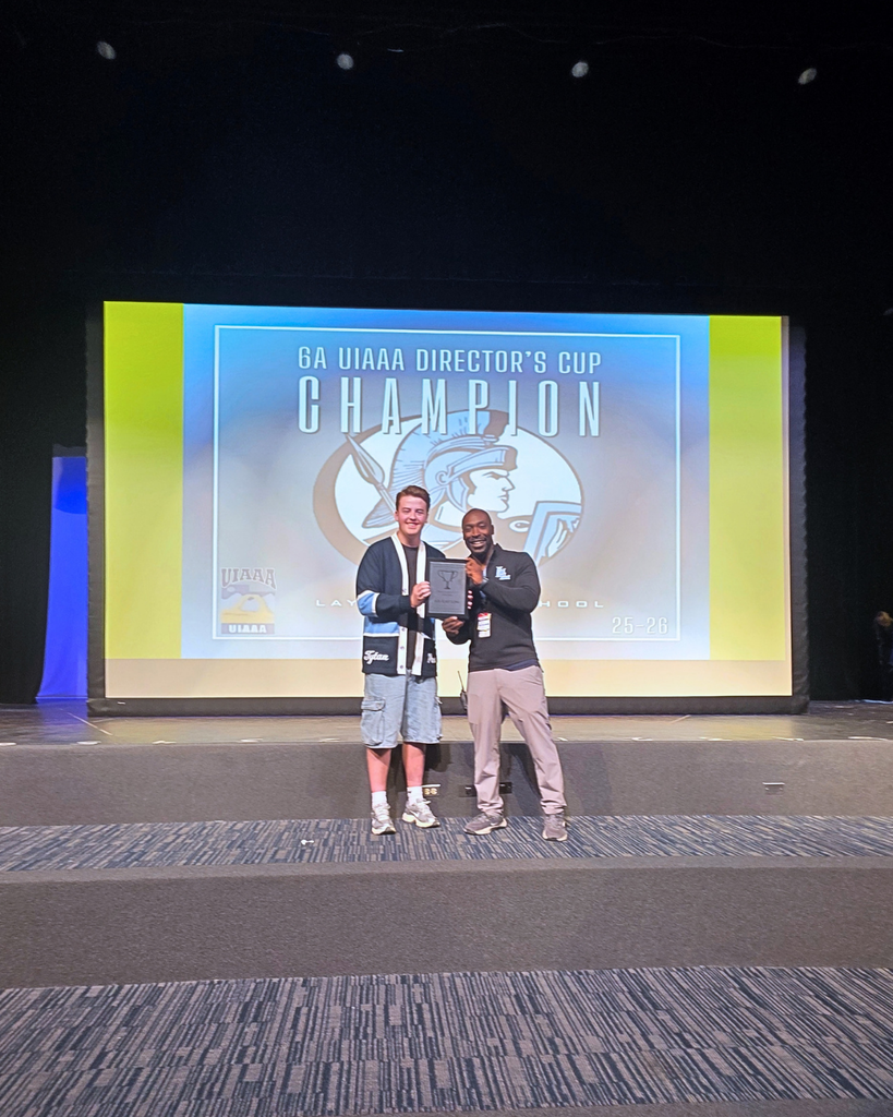 Layton High School principal Corby Eason and a Layton High School student body officer holding up a plaque for the 6A UIAAA Director's Cup. 